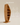 Sculptural curved leaf-shaped wooden bookshelf with angled display compartments, natural light wood finish — handcrafted artistic wooden shelf made in India.