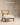 Wooden accent chair with cane backrest and white upholstered cushion seat, walnut finish — handcrafted lounge chair made in India.