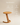 Sculptural round wooden side table with single angled leg and curved cantilevered base, natural light wood finish — handcrafted modern accent table made in India.