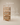 Wooden storage rack with three cane-woven open bins, natural light wood finish — handcrafted wooden basket organizer made in India.