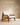 Mid-century wooden lounge chair with cane side panels, angled wooden frame and white upholstered cushions — handcrafted accent chair made in India.