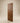 Front view of a contemporary walnut wooden entrance door featuring diagonal plank panels, geometric chevron accents, and a natural wood grain finish.