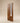 Premium solid wood main door with vertical slatted walnut finish, featuring a tall rounded-bottom frosted glass insert, slim modern profile and brass pull handle