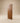 Front view of a contemporary geometric walnut wooden entrance door featuring diagonal panel design and natural wood grain.