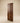 Front view of a modern solid wooden door featuring minimalist geometric groove design.