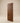 Front view of a contemporary walnut wooden entrance door featuring diagonal plank design with natural wood grain and a minimalist modern finish.