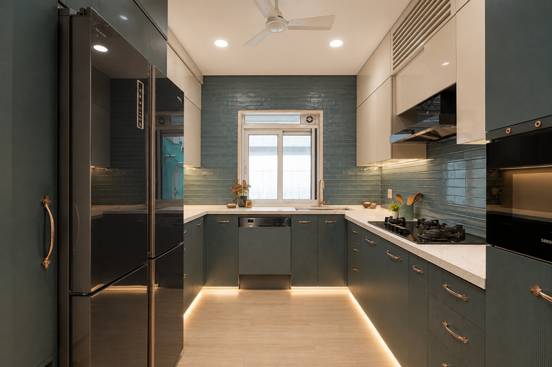 Modern kitchen with dark gray cabinets, stainless steel appliances, and a window.