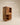 Tall wooden cabinet with geometric chevron-carved doors, open shelves and middle drawer, walnut finish — handcrafted wooden storage cupboard made in India.