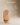 Sculptural pill-shaped wooden wall shelf with curved fluted carving and floating ledge, natural light wood finish — handcrafted decorative wall shelf made in India.