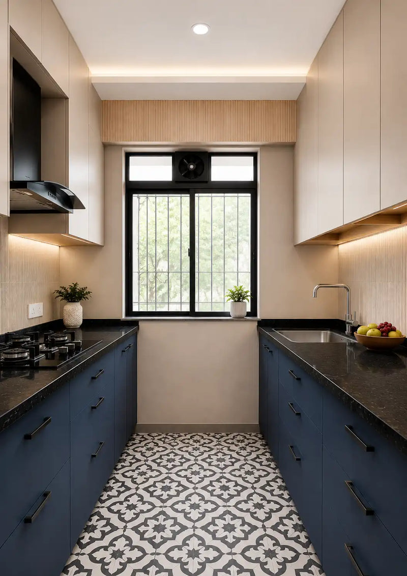 Modern kitchen with blue cabinets, black countertops, and a window above the sink.