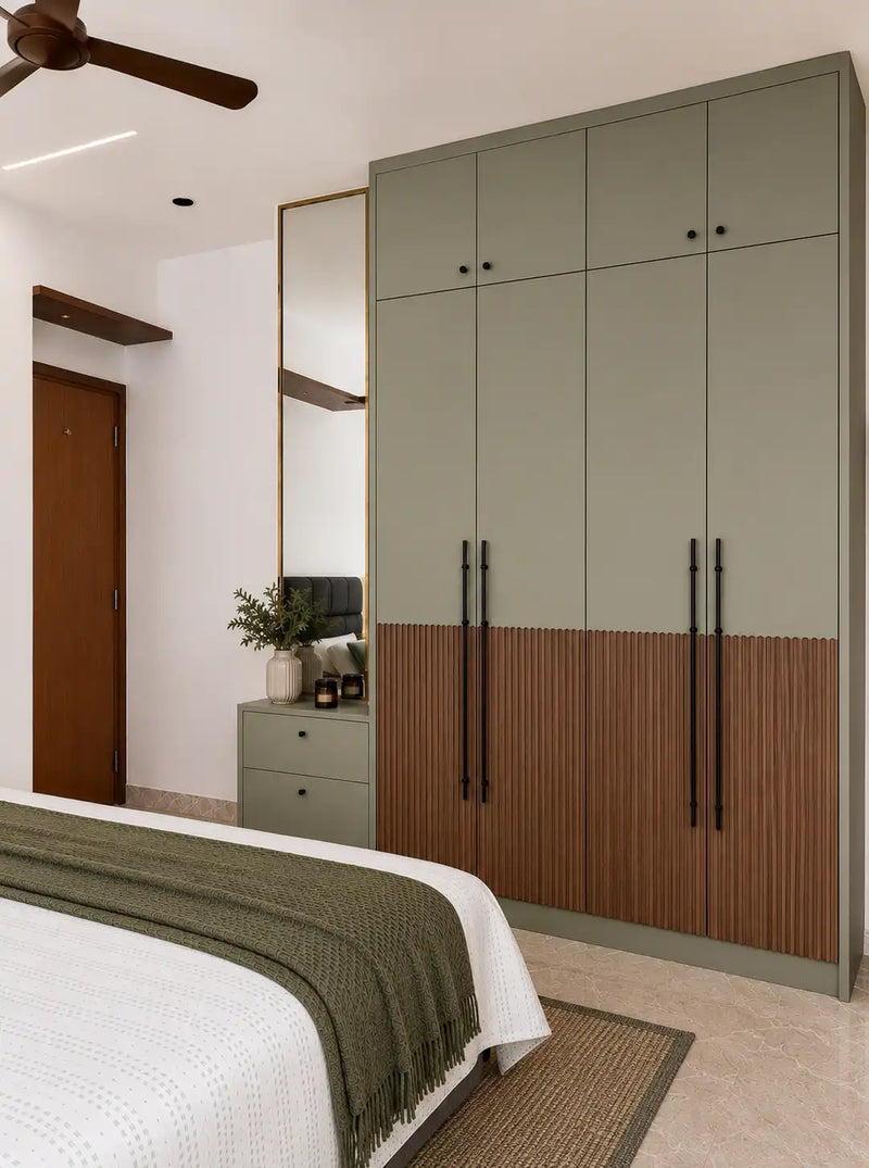Bedroom with a large green wardrobe and bed with green blanket