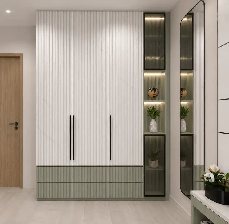 Modern wardrobe with glass panels and decorative items in a room.